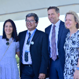 two-couples-stand-together-outside-at-the-groundbreaking-ceremony