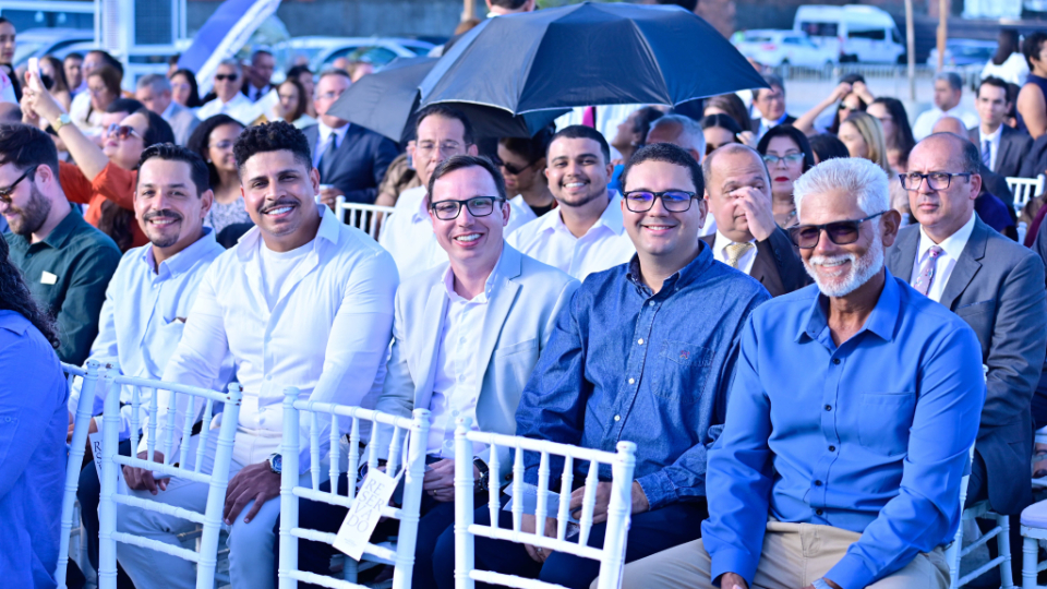 a-group-of-people-smile-during-a-groundbreaking-ceremony
