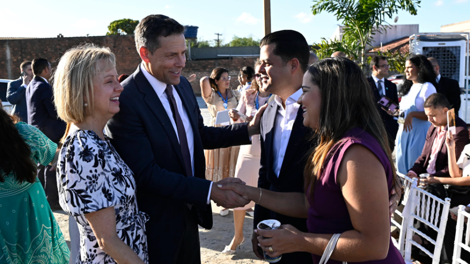 Elder B. Corey Cuvelier of the Brazil Area Presidency and his wife, Wendi, greet guests at the groundbreaking ceremony for the Maceió Brazil Temple in Maceió, Brazil, on October 10, 2026.