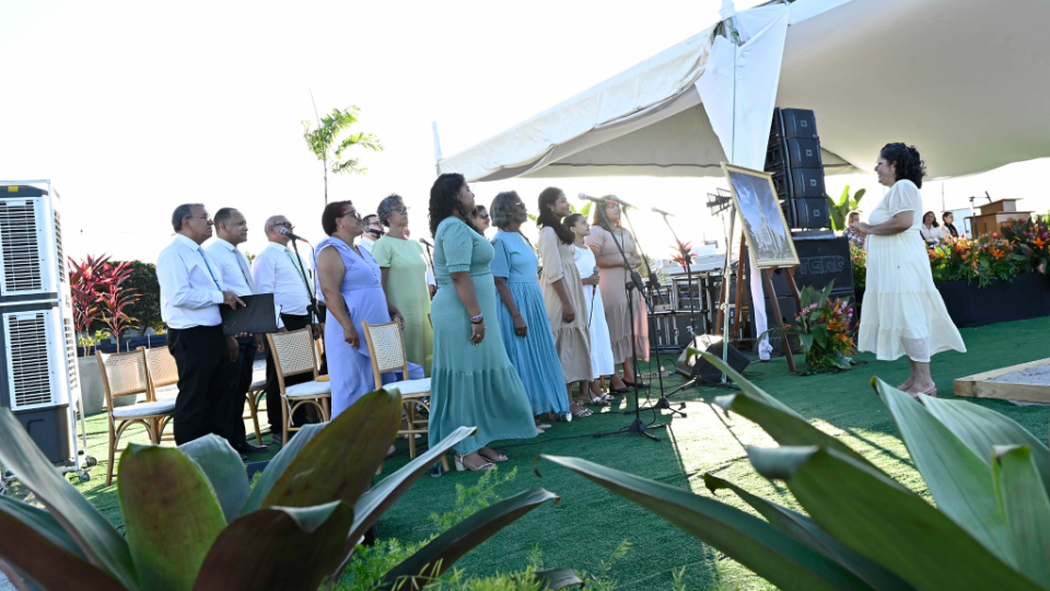 a-choir-sings-outside-at-a-groundbreaking-ceremony
