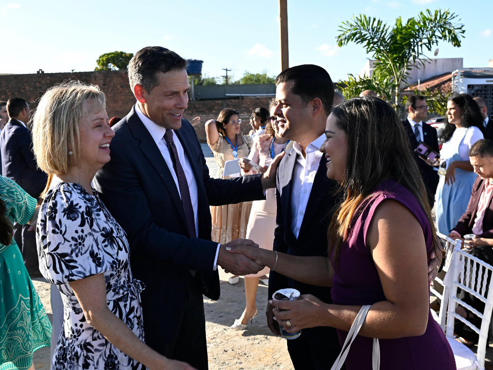 Elder B. Corey Cuvelier of the Brazil Area Presidency and his wife, Wendi, greet guests at the groundbreaking ceremony for the Maceió Brazil Temple in Maceió, Brazil, on October 10, 2026.